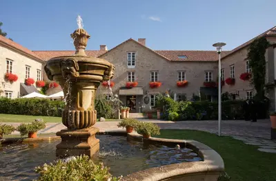 a fountain in the courtyard of a building at A Quinta Da Auga Hotel Spa Relais & Chateaux in Santiago de Compostela