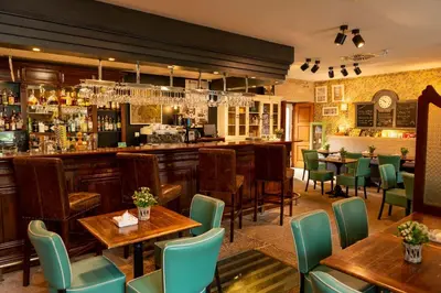 a restaurant with tables and chairs and a bar at A Quinta Da Auga Hotel Spa Relais & Chateaux in Santiago de Compostela