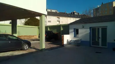 a car parked in a parking lot next to a house at Santa Cruz in Ribadeo
