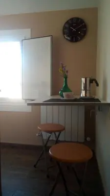 a kitchen with a counter and a clock on the wall at Santa Cruz in Ribadeo