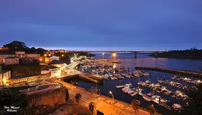 a harbor with boats in the water at night at Santa Cruz in Ribadeo