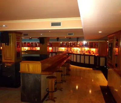 a bar with a long counter in a room at Hotel Scala in Padrón