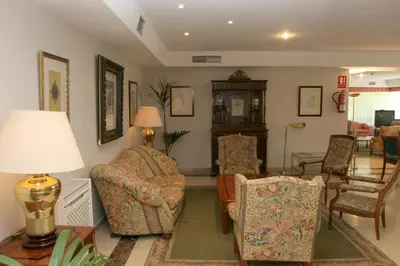 a living room with chairs and a table at Pousada de Portomarín in Portomarin