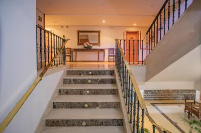 a set of stairs in a house with wrought iron railings at Pousada de Portomarín in Portomarin