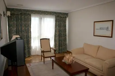 a living room with a couch and a tv at Pousada de Portomarín in Portomarin