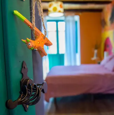 a toy animal hanging from a string in a bedroom at Hotel Rural Casa Indie in Rabanal del Camino