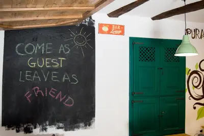 a chalkboard with a sign that says come as guest leaves friend at Hotel Rural Casa Indie in Rabanal del Camino