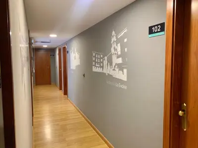 a hallway with a sign on a wall at Hotel Los Templarios in Ponferrada