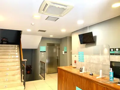 a hospital lobby with a room with a ceiling fan at Hotel Los Templarios in Ponferrada