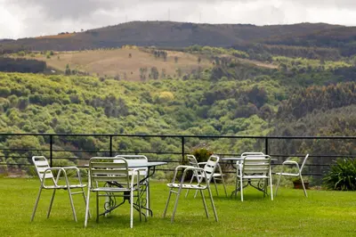 a group of chairs and a table on a field at Rectoral de Fofe in Fofe