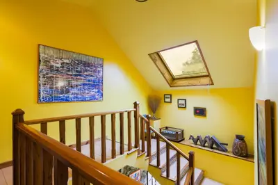 a staircase in a house with yellow walls at Rectoral de Fofe in Fofe