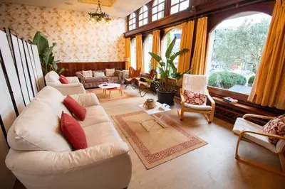 a living room with white furniture and a large window at Hotel Montero in Mondoñedo