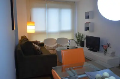 a living room with a couch and a table at Apartamentos Antares 1 in Milladoiro