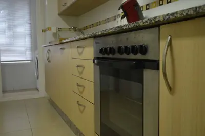 a kitchen with a stainless steel stove top oven at Apartamentos Antares 1 in Milladoiro