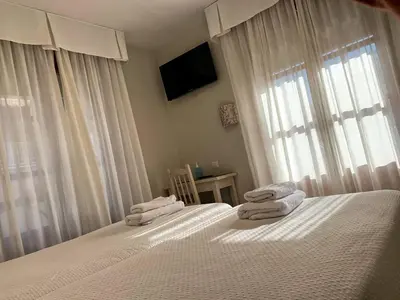 a bedroom with two beds with towels on them at Hostal Restaurante Méndez in Villafranca del Bierzo