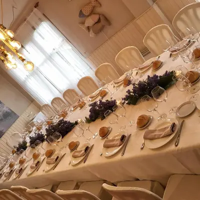 a long table with silverware and flowers on it at Hostal Restaurante Méndez in Villafranca del Bierzo