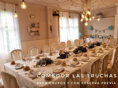 a long table in a room with white tables and chairs at Hostal Restaurante Méndez in Villafranca del Bierzo