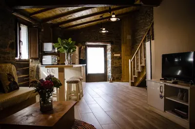 a room with a kitchen and a bedroom at Casa Turística Viladonatus (Ribeira Sacra) in Doade