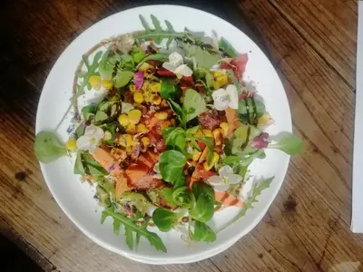 a salad on a white plate on a table at Casa Licerio in Samos