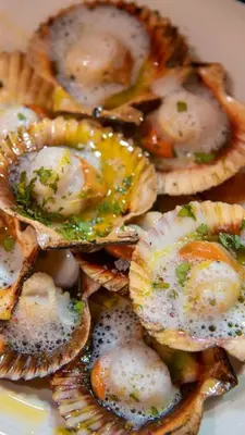 a plate of oysters with ingrediants on top at Posada Real La Pascasia in Puebla de Sanabria