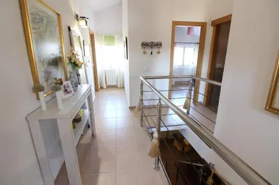 a bedroom with a large bed with white sheets at Villa Albaredo in Villameá