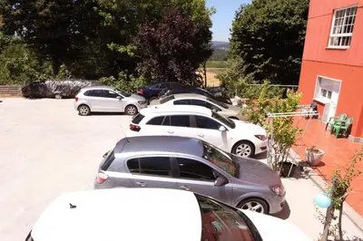 a row of parked cars in a parking lot at Hotel Santa Cruz in Montaos