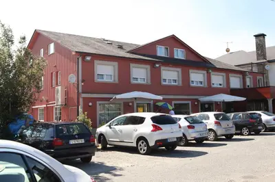 a row of cars parked in front of a building at Hotel Santa Cruz in Montaos