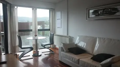 a living room with a couch and a table at Descanso Termal in Ourense