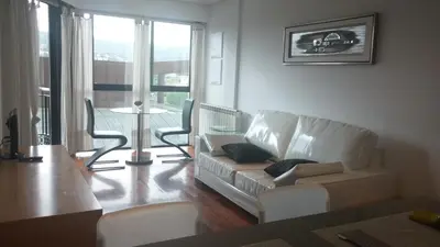 a living room with a couch and chairs and a table at Descanso Termal in Ourense