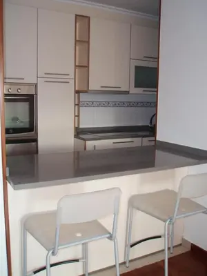 a kitchen with two chairs and a counter top at Descanso Termal in Ourense