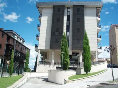 a building with trees in front of it at Descanso Termal in Ourense