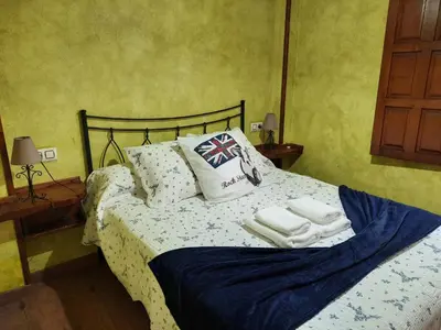 a bedroom with a bed with towels on it at Casa Viduedo in Santa Eulalia de Oscos