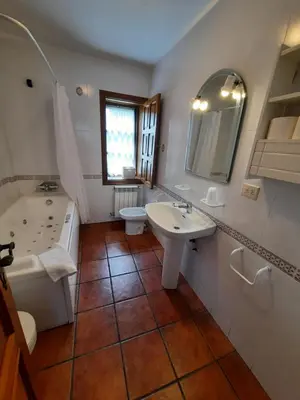 a bathroom with a sink and a tub and a toilet at Casa Viduedo in Santa Eulalia de Oscos