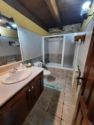 a bathroom with a sink and a toilet and a tub at Casa Viduedo in Santa Eulalia de Oscos