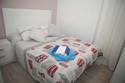 a bedroom with a bed with a british flagitarianitarian at El Apartamento de María in Lugo