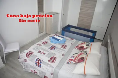 a bedroom with a bed with a bedspread with british flags at El Apartamento de María in Lugo