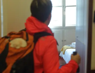 a young child standing in a bedroom looking into a mirror at Hotel Santa Clara in Santiago de Compostela