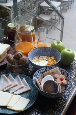 a table with plates of food and apples and bread at Hotel Santa Clara in Santiago de Compostela