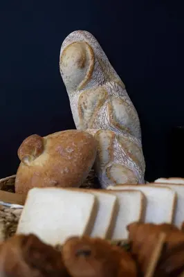a group of bagels and bread in a basket at Hotel Santa Clara in Santiago de Compostela