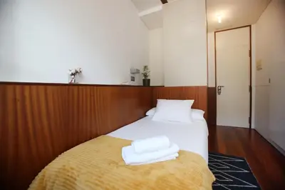 a bedroom with a bed with two towels on it at Hotel Santa Clara in Santiago de Compostela
