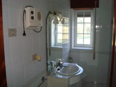 a bathroom with a sink and a mirror at Casa do Xastre in Baralla