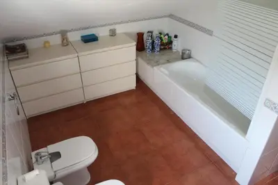 a bathroom with a toilet and a bath tub at Casa do Xastre in Baralla