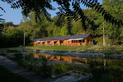 a house in the middle of a river at Albergue Casa del Pescador in Ambasmestas