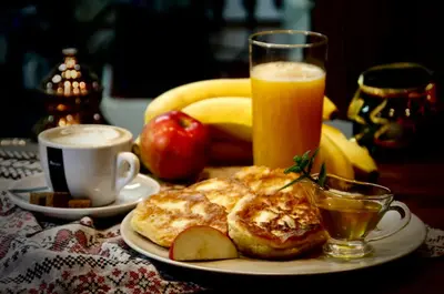 a plate of breakfast food with a glass of orange juice at Albergue Casa del Pescador in Ambasmestas