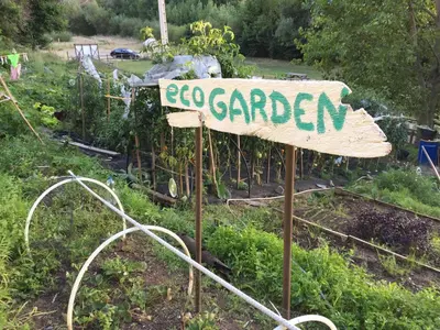 a garden sign in the middle of a garden at Albergue Casa del Pescador in Ambasmestas