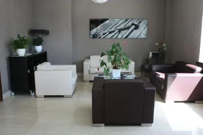 a living room with couches and chairs and a table at Hotel Pontes do Eume in Puentes de García Rodríguez