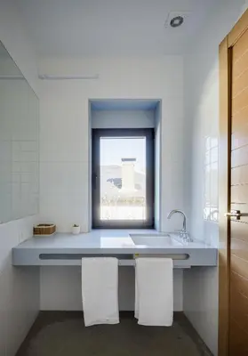 a bathroom with a sink and a window at Casa la Devesa de Sanabria in Remesal