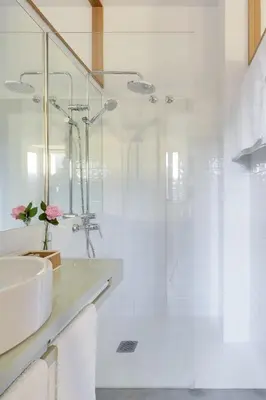 a white bathroom with a sink and a shower at Casa la Devesa de Sanabria in Remesal