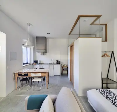 a living room and kitchen with a table and a couch at Casa la Devesa de Sanabria in Remesal
