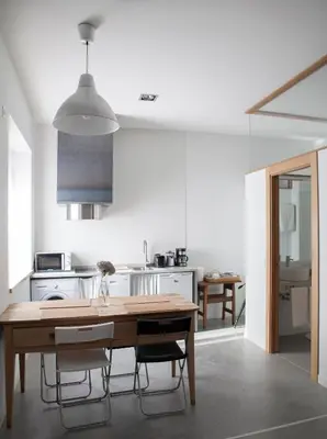 a kitchen with a wooden table and some chairs at Casa la Devesa de Sanabria in Remesal